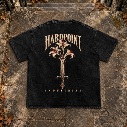 HARDPOINT Floral Blade Snow-Washed Oversized Tee, Black, back view on aged stone steps. AI-styled product mockup.