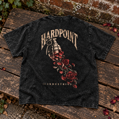 HARDPOINT Grenade & Roses tee, back view on a weathered garden bench. AI-styled product mockup.