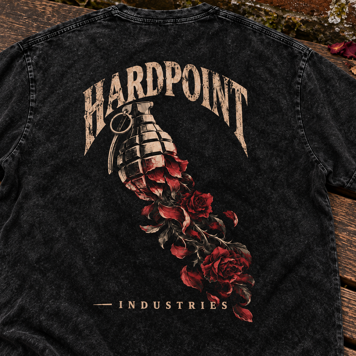 HARDPOINT Grenade & Roses tee, detail view on a weathered garden bench. AI-styled product mockup.