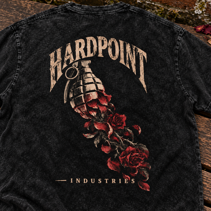 HARDPOINT Grenade & Roses tee, detail view on a weathered garden bench. AI-styled product mockup.