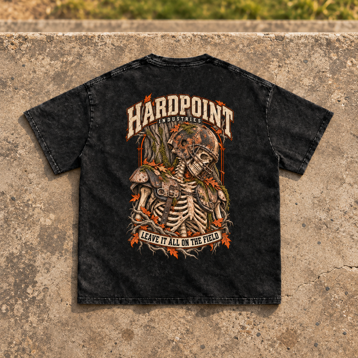 HARDPOINT Leave It All on the Field Snow-Washed Oversized Tee, Black, back view on sports-field concrete landing. AI-styled product mockup.