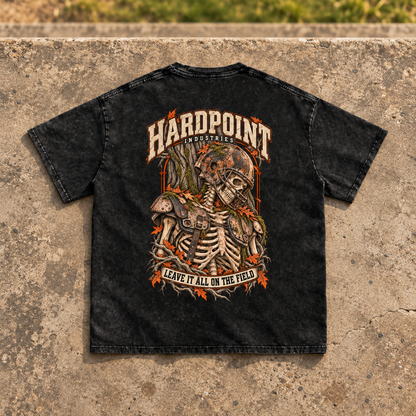 HARDPOINT Leave It All on the Field Snow-Washed Oversized Tee, Black, back view on sports-field concrete landing. AI-styled product mockup.