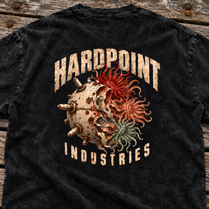 HARDPOINT Tentacle Shell tee, Black, detail view on a weathered dock. AI-styled product mockup.